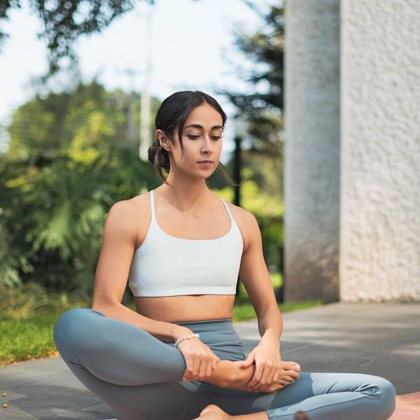 Person meditating peacefully in a serene natural setting.
